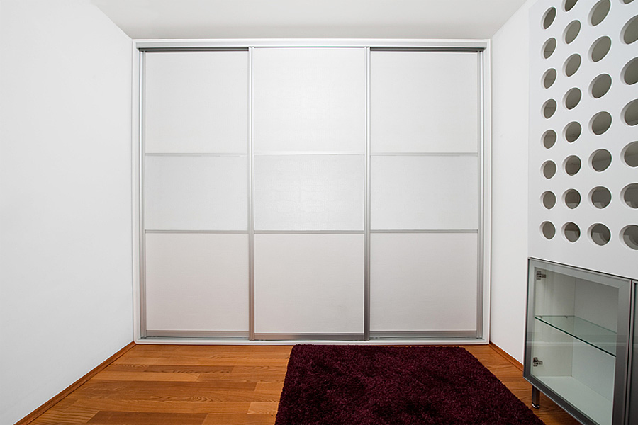 Sliding wardrobe doors within a frame